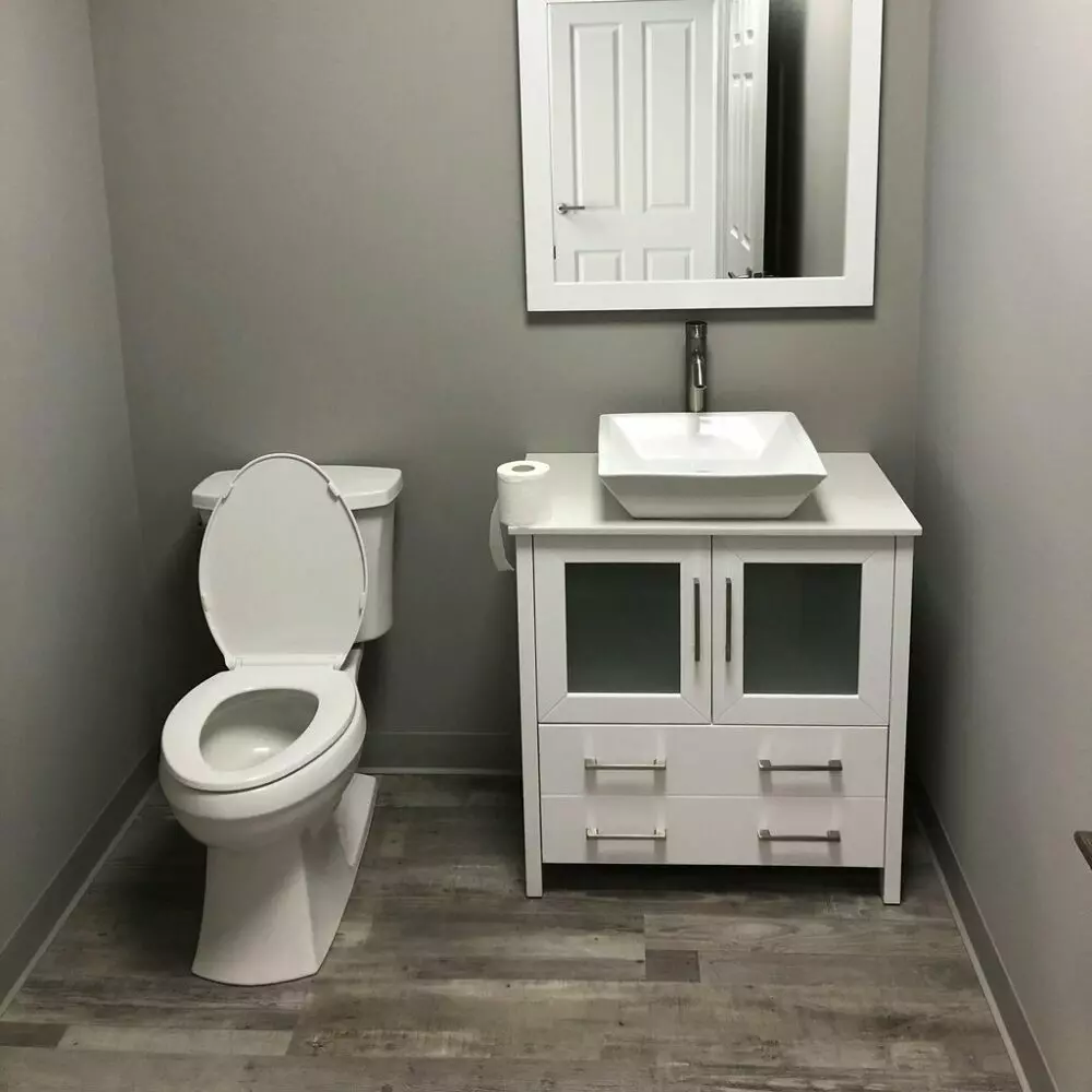Small Half Bathroom with Mute Step Grey Ash flooring.